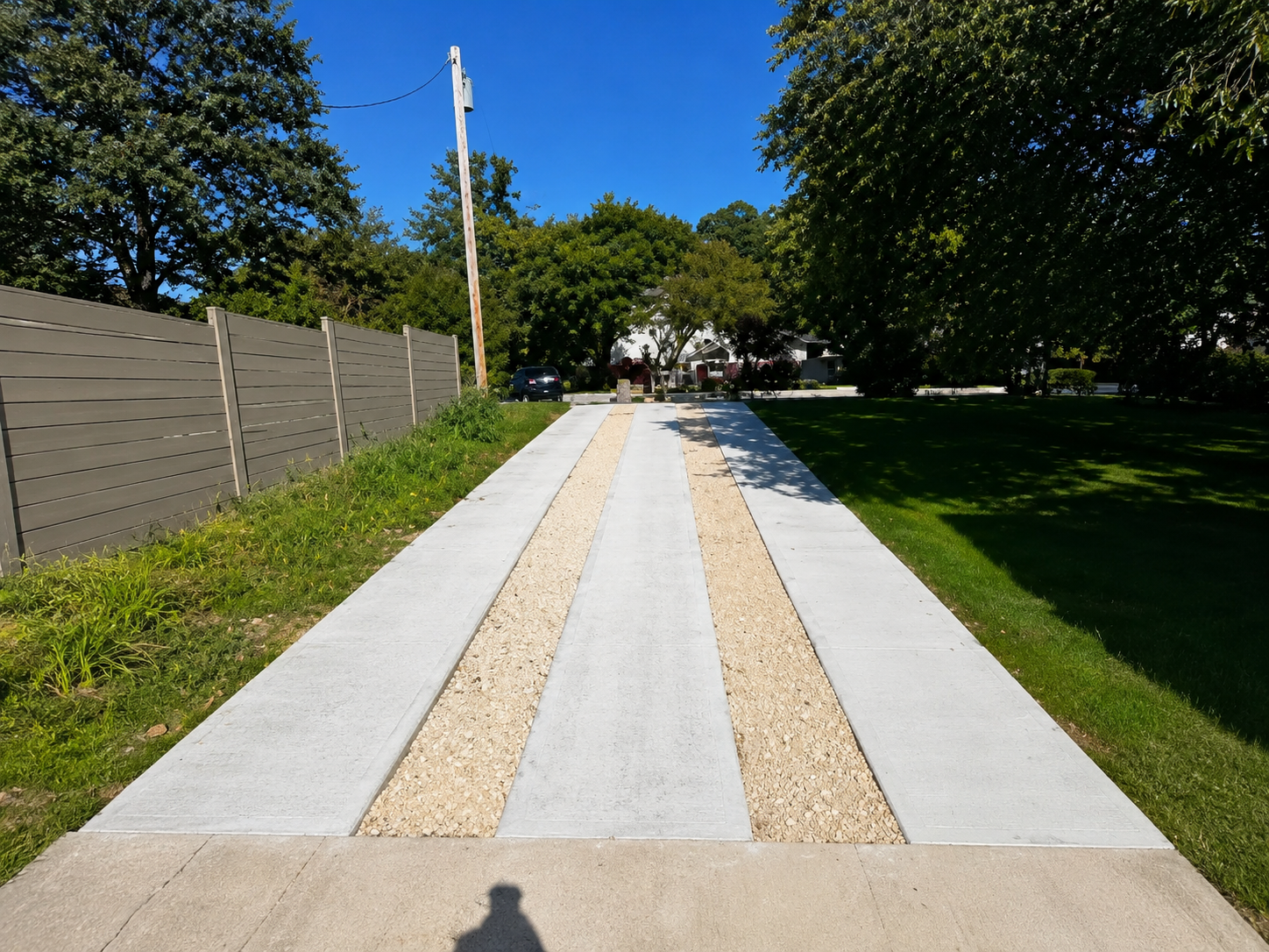 Real Austin Yard Oasis hardscaping project photo: custom concrete and gravel walkway in a residential Austin yard
